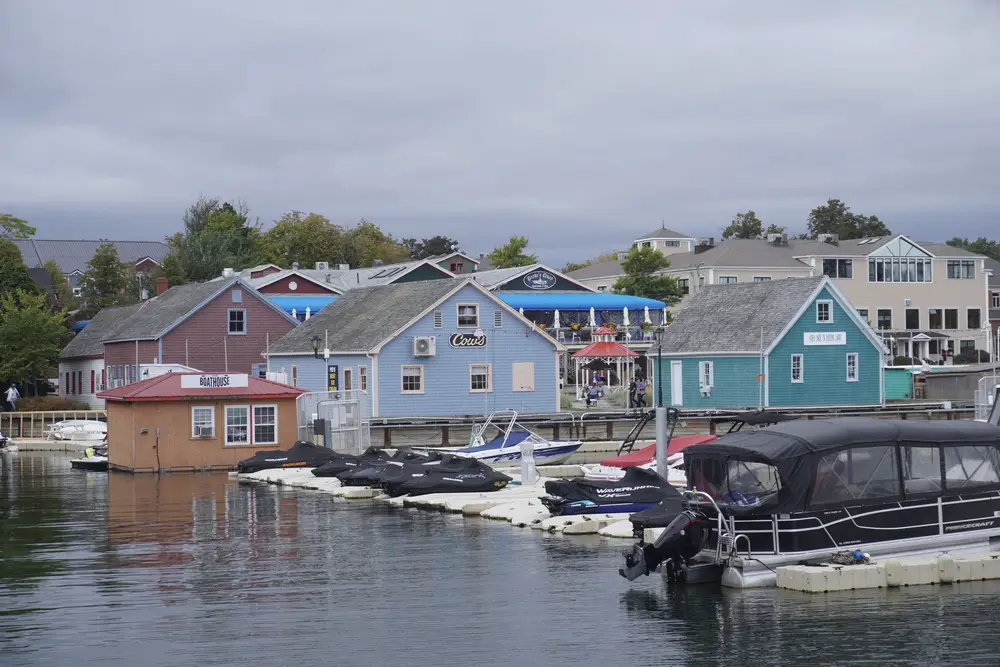 Painted waterfront buildings and moored boats along a harbor